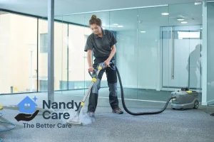 A Nandy Care cleaner performing steam carpet cleaning in a modern office space. Perfect for end-of-lease cleans, offices, and deep hygiene refreshes.